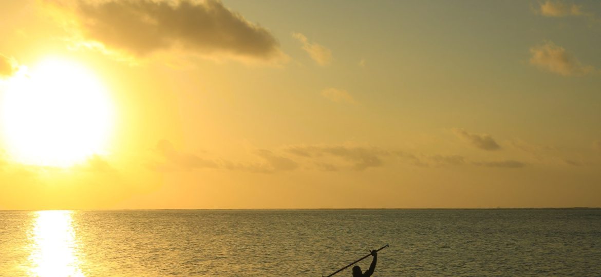 A person paddle boarding under the sunset on the Indian ocean just off the beach of Bahari Beach hotel, Nyali Mombasa.