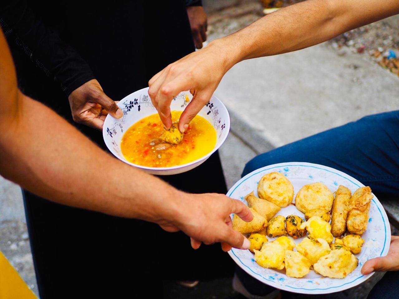 A group of people enjoying Swahili dishes.