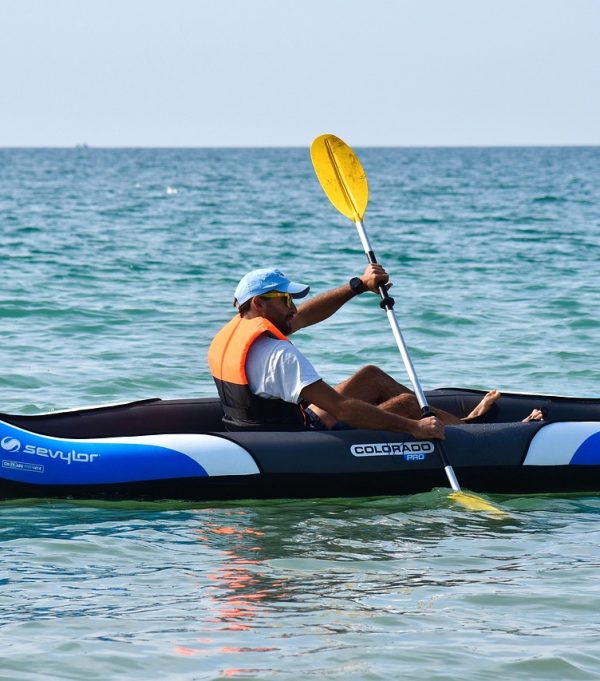 Man kayaking in the ocean.