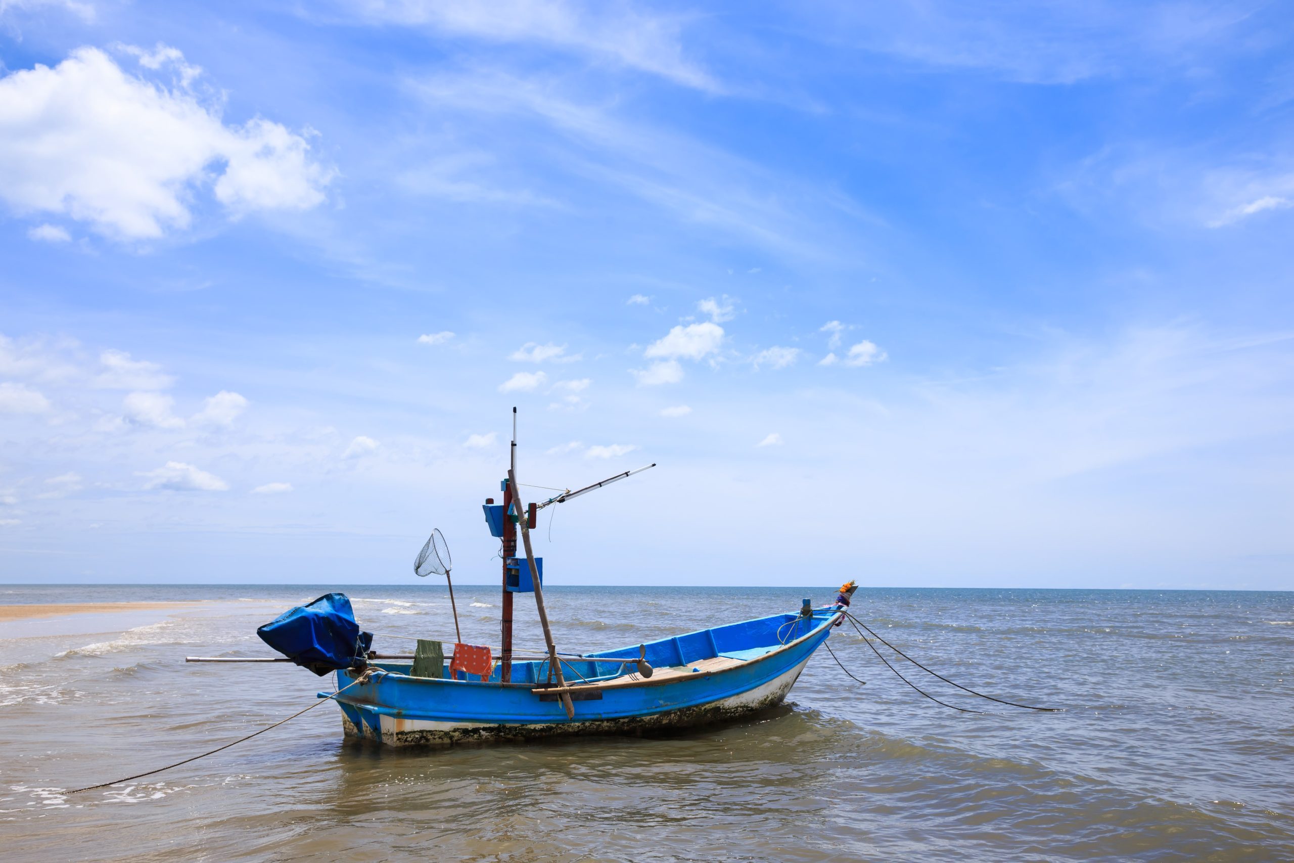Traditional Fishing Boat floating on blue water.